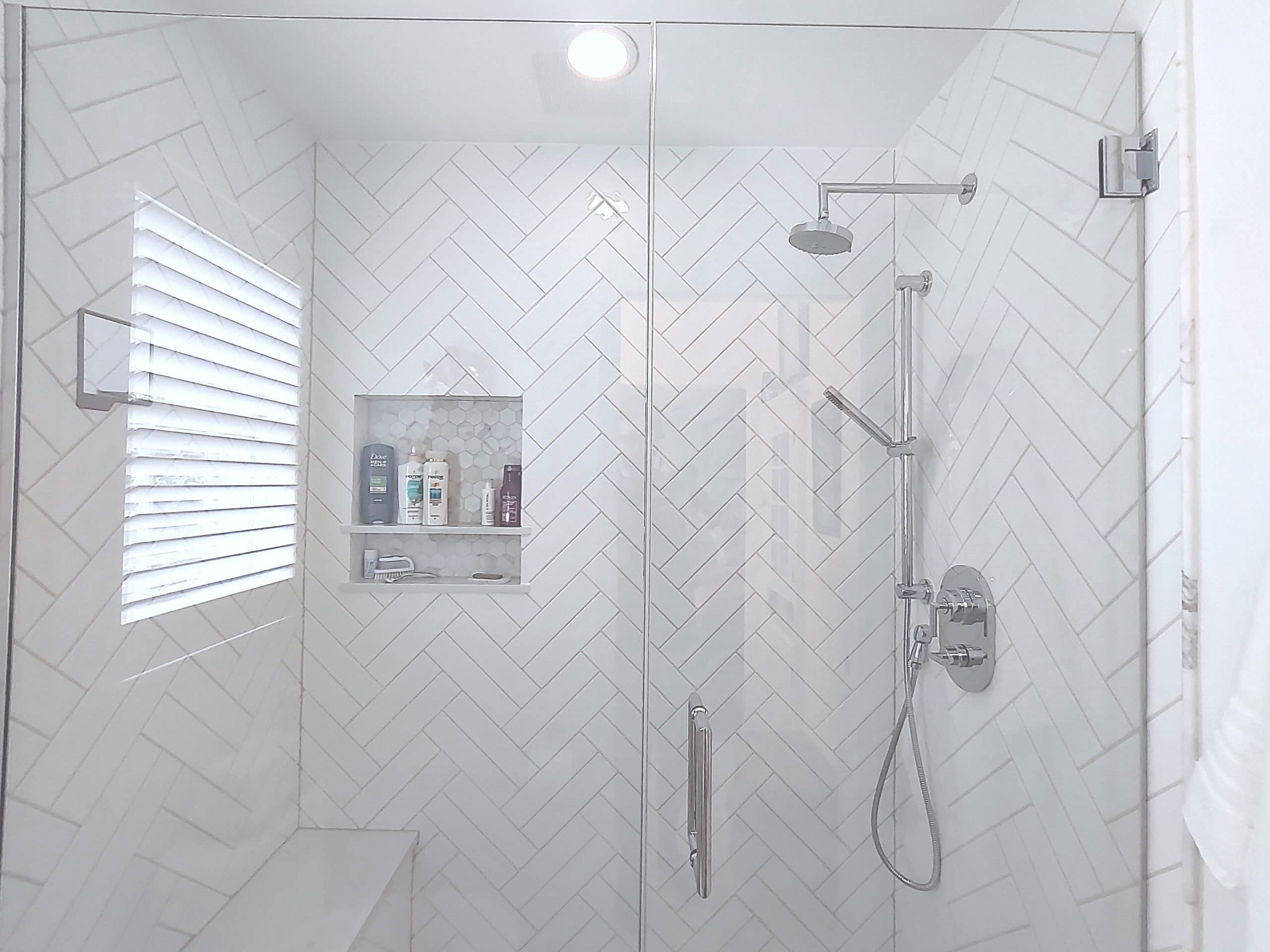Walk-in shower with double herringbone tile walls