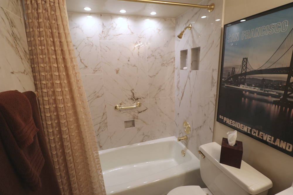 Bathroom Remodel featuring a tiled tub surround with large-format porcelain tile